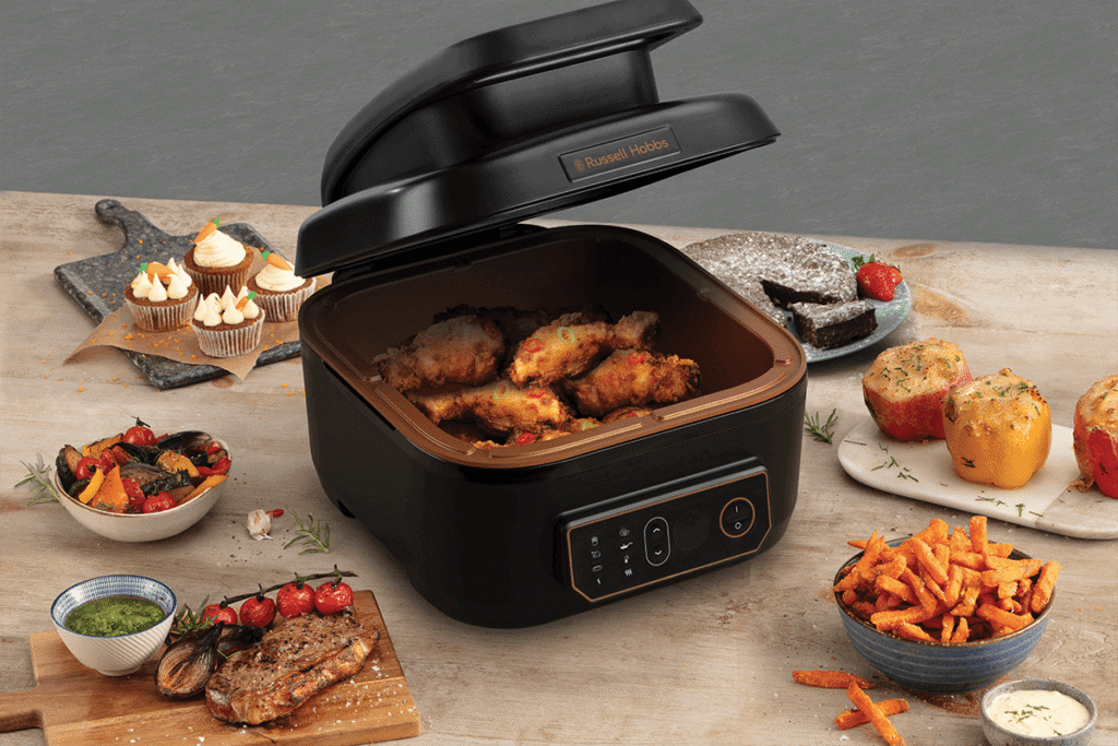 Air fryer with digital controls cooking crispy chicken and vegetables efficiently.